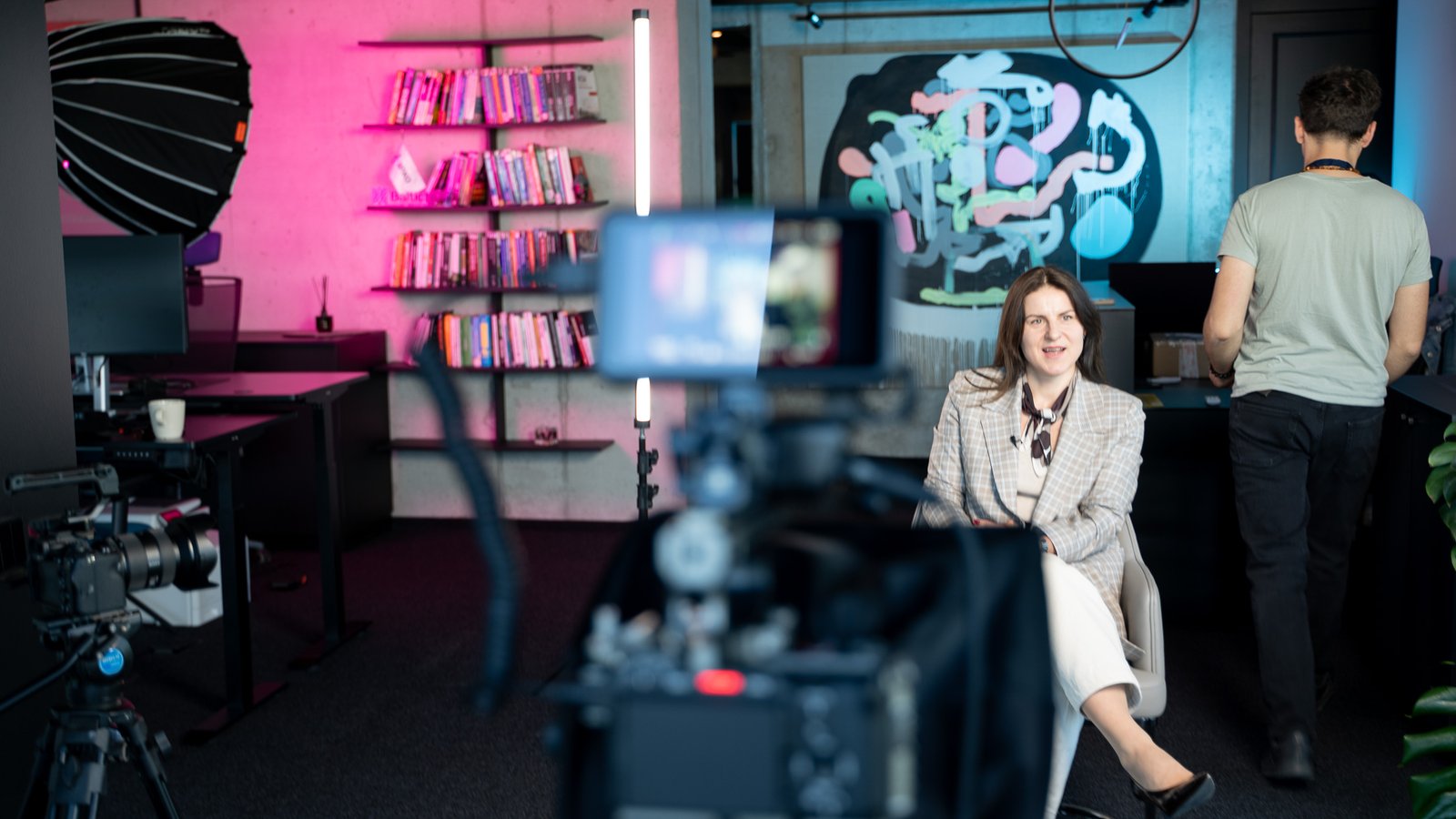 Client interview shoot in a creative studio with a graffiti mural and accent lighting